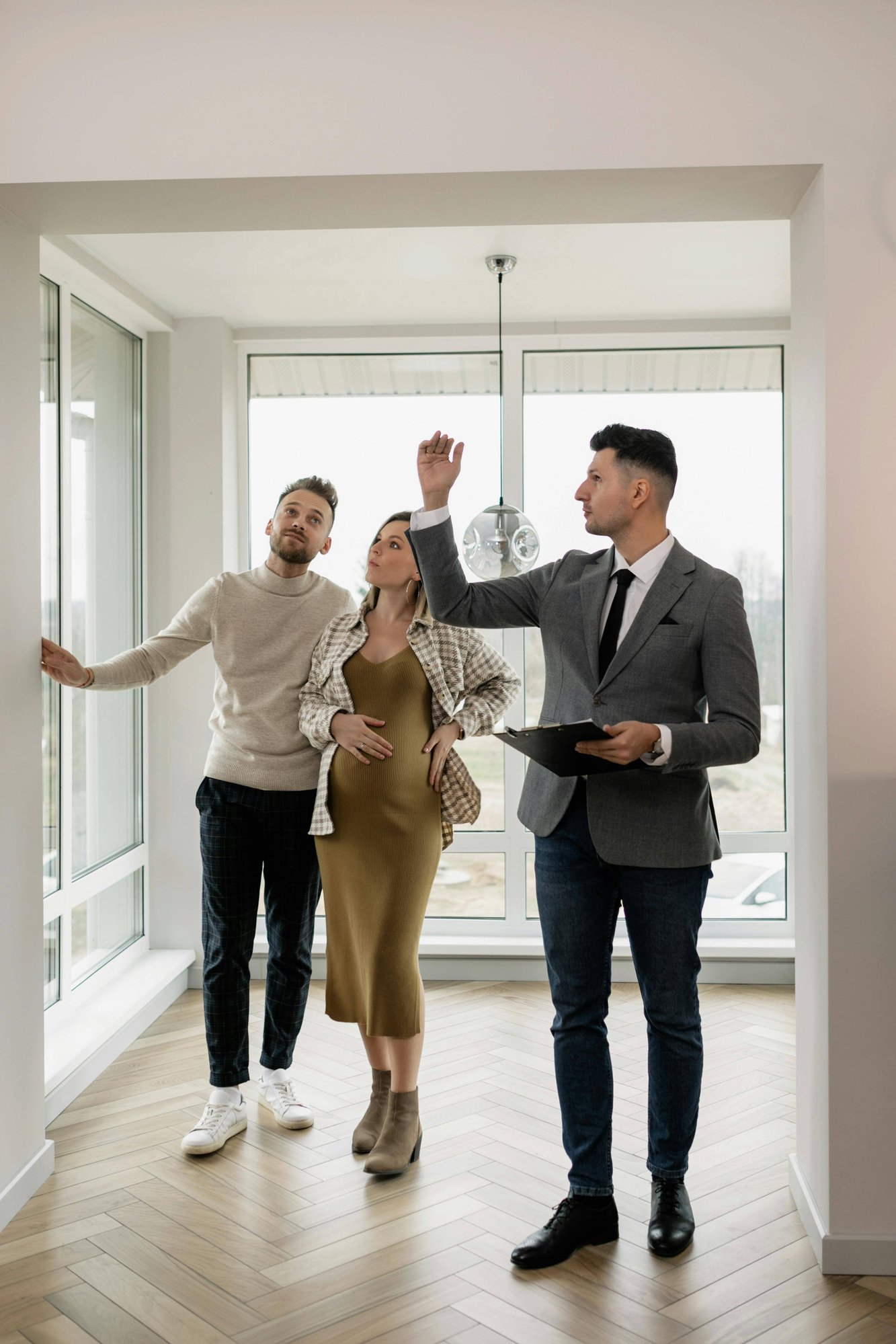 real-estate-agent-showing-property-to-a-couple real-estate-agent-showing-property-to-a-couple