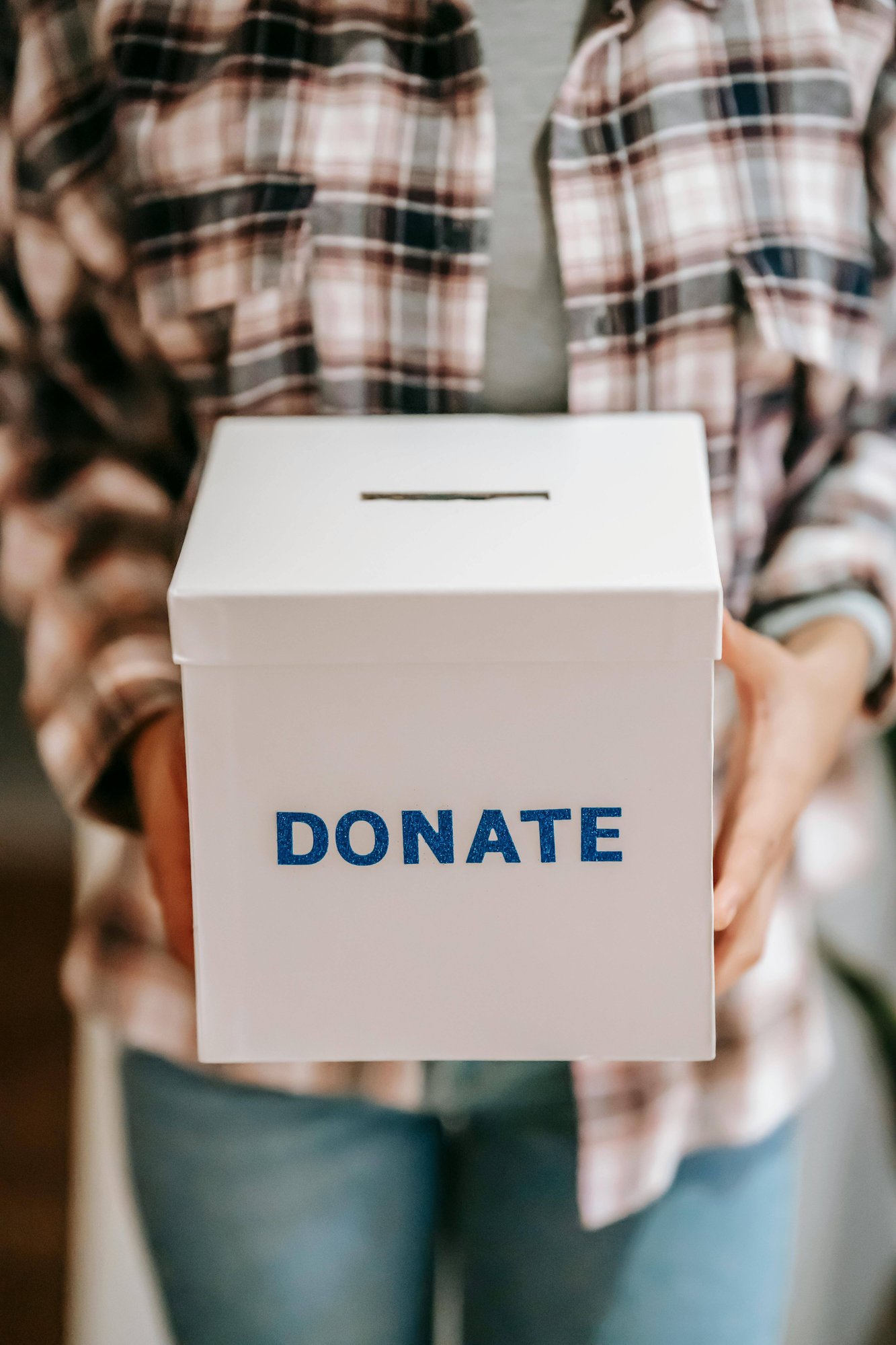crop-anonymous-person-showing-donation-box