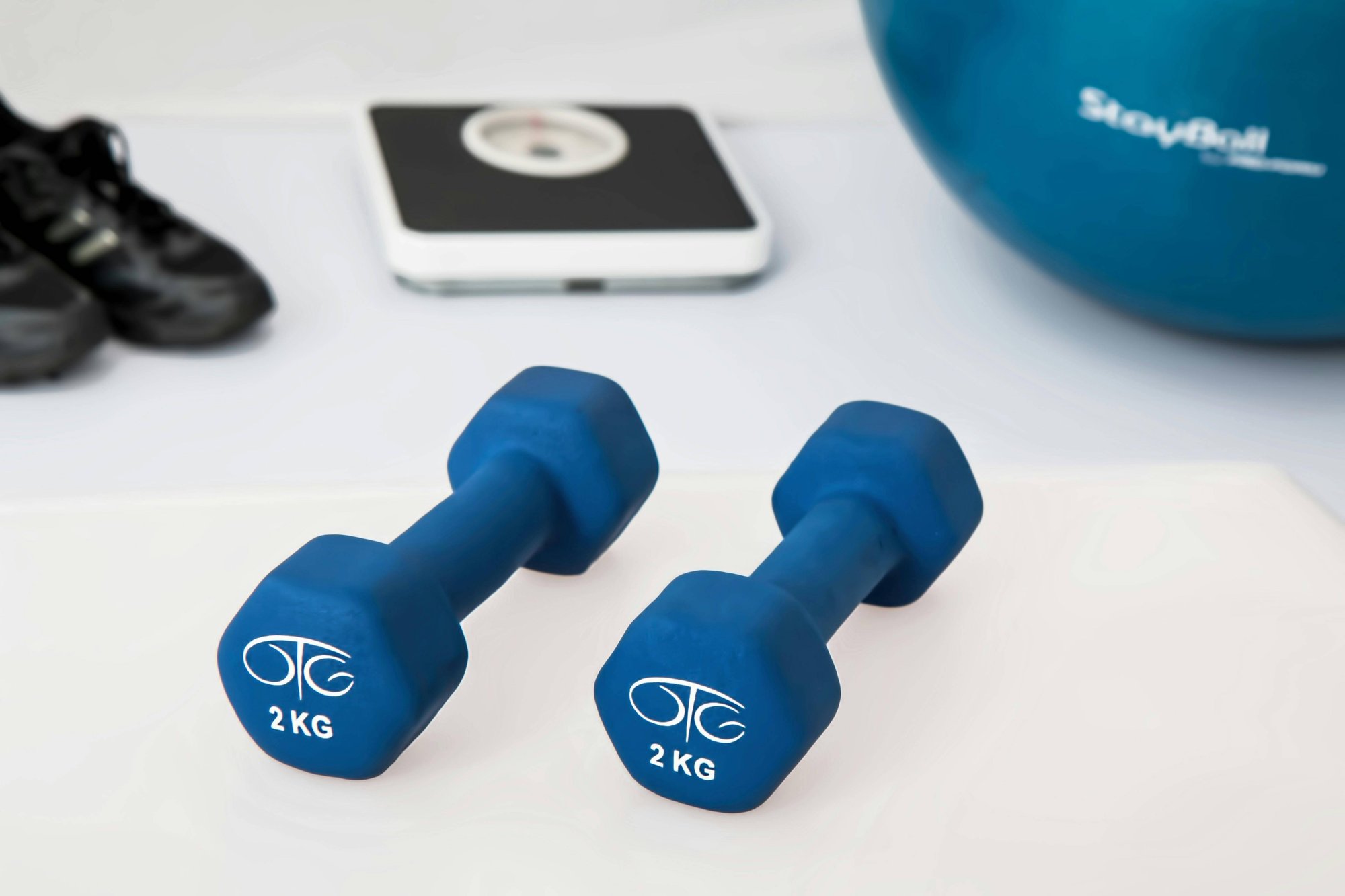 two-2-kg-blue-hex-dumbbells-on-white-surface